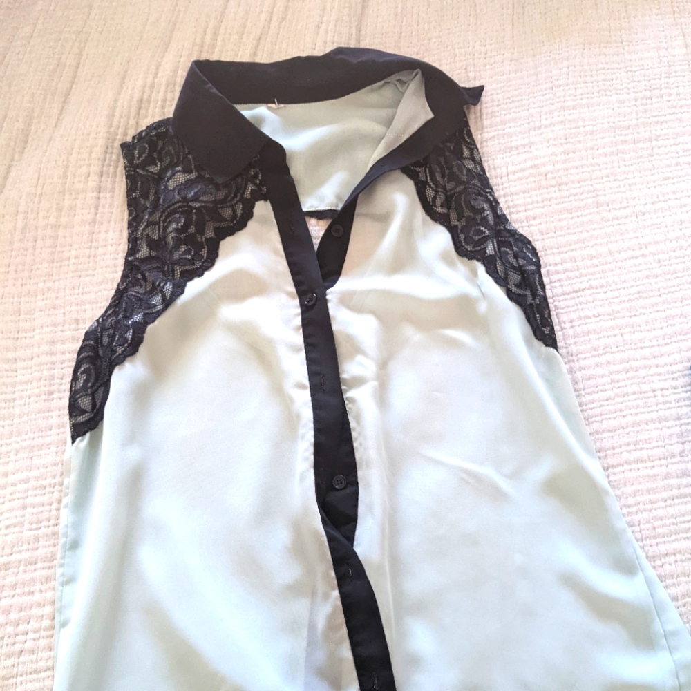 Mint see through sleeveless blouse.   Black lace detail.